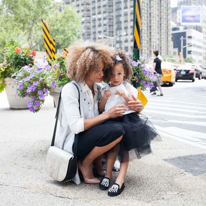Mom posing with her daughter on the street